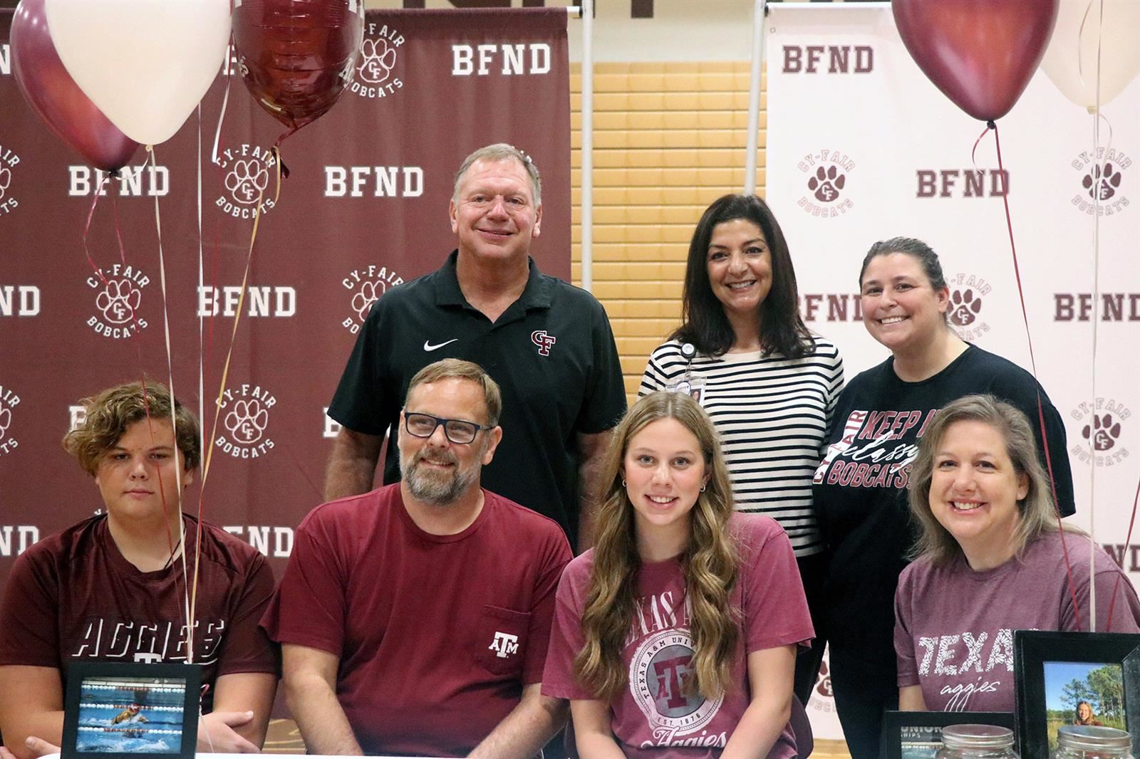 Cy-Fair High School senior Ella Smoker, seated second from right, signed a letter of intent to swim collegiately at Texas A&M